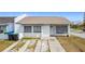 Charming home featuring white stucco, neutral roof, tidy front yard, and welcome decor at 2803 Charing Cross Way, Orlando, FL 32837