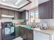 Kitchen with white countertops, dark wood cabinets, and stainless steel sink at 2803 Charing Cross Way, Orlando, FL 32837
