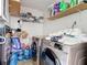 Laundry room with side-by-side washer and dryer and shelving for storage at 2803 Charing Cross Way, Orlando, FL 32837