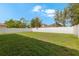 Expansive backyard area enclosed by a white vinyl fence, offering privacy and room for recreation at 2806 Polson Dr, Kissimmee, FL 34758