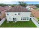 Exterior shot of the home featuring a spacious backyard with a well-maintained lawn and white fence at 2806 Polson Dr, Kissimmee, FL 34758