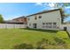 The backyard features a white fence, sliding glass doors and a view of neighboring properties at 2806 Polson Dr, Kissimmee, FL 34758