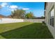 A spacious backyard with well maintained lawn and partial view of the screened in pool at 2806 Polson Dr, Kissimmee, FL 34758