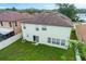 Exterior photo of the home featuring a well-maintained lawn with a white fence and sliding glass door at 2806 Polson Dr, Kissimmee, FL 34758