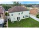Exterior shot of the home highlighting the spacious backyard, white fence, and sliding glass doors at 2806 Polson Dr, Kissimmee, FL 34758