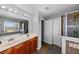 The bathroom offers a double sink vanity, and tiled walk-in shower with glass doors at 2806 Polson Dr, Kissimmee, FL 34758