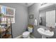 Bright bathroom features a pedestal sink, decor and a white door with an attached mirror at 2806 Polson Dr, Kissimmee, FL 34758