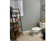 Small bathroom featuring a toilet, shelving, and decorative signs at 2806 Polson Dr, Kissimmee, FL 34758