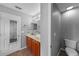This bathroom has double sinks with wood cabinets, a medicine cabinet, and a commode at 2806 Polson Dr, Kissimmee, FL 34758
