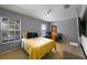 Cozy bedroom featuring a yellow bedspread, two windows, and a ceiling fan at 2806 Polson Dr, Kissimmee, FL 34758