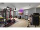 A spacious bonus room features a home gym and a large screen television at 2806 Polson Dr, Kissimmee, FL 34758