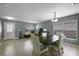 Dining room with modern table and chairs, tile floors, and natural light at 2806 Polson Dr, Kissimmee, FL 34758