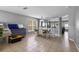 Dining room with tile floors connects to the living room with a view of a large sectional sofa at 2806 Polson Dr, Kissimmee, FL 34758