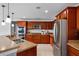 Kitchen featuring stainless steel appliances, wood cabinets, and stone countertops at 2806 Polson Dr, Kissimmee, FL 34758