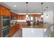 Kitchen featuring stainless steel appliances, wood cabinets, and countertop overhang at 2806 Polson Dr, Kissimmee, FL 34758