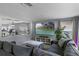 Spacious living room with a large sectional sofa, mounted TV, and a connecting dining room at 2806 Polson Dr, Kissimmee, FL 34758