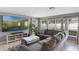 Comfortable living room features a large sectional sofa, a mounted TV, and tile floors at 2806 Polson Dr, Kissimmee, FL 34758