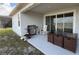 View of the back patio with a stainless steel grill and a brown wicker table and chair set at 2926 Wordsmith Rd, Kissimmee, FL 34746