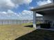 Backyard with a water view from covered lanai with grill at 2926 Wordsmith Rd, Kissimmee, FL 34746