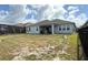 Spacious fenced backyard with an extended covered patio with outdoor furniture and lake views at 2926 Wordsmith Rd, Kissimmee, FL 34746