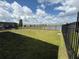 Backyard with grassy area and views of a lake and surrounding houses at 2926 Wordsmith Rd, Kissimmee, FL 34746