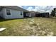 Large backyard with a screened-in porch and back patio overlooking the fenced-in yard at 2926 Wordsmith Rd, Kissimmee, FL 34746