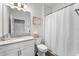 Bathroom featuring a single sink vanity, toilet, and shower with shower curtain at 2926 Wordsmith Rd, Kissimmee, FL 34746