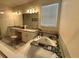 Relaxing bathroom offering a soaking tub with garden views and double vanity at 2926 Wordsmith Rd, Kissimmee, FL 34746