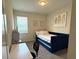 Bedroom with a trundle bed, desk, chair, and window with blinds at 2926 Wordsmith Rd, Kissimmee, FL 34746