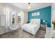 Chic bedroom with a teal accent wall, white furniture, and stylish decor at 2926 Wordsmith Rd, Kissimmee, FL 34746