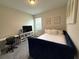 Bedroom with trundle bed, desk, chair, window with blinds and a television at 2926 Wordsmith Rd, Kissimmee, FL 34746