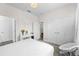 Bright bedroom featuring a white bed, neutral decor, and ample closet space at 2926 Wordsmith Rd, Kissimmee, FL 34746