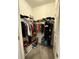 Walk in closet showing shelving and clothes racks with clothes and personal items at 2926 Wordsmith Rd, Kissimmee, FL 34746