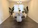Formal dining room boasting a modern chandelier, large window, and greenery at 2926 Wordsmith Rd, Kissimmee, FL 34746