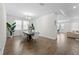 Open dining room features wood floors, decorative plants, modern furniture and view to living area at 2926 Wordsmith Rd, Kissimmee, FL 34746