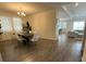 Open-concept dining area featuring modern light fixtures, wood floors, and bright, natural light at 2926 Wordsmith Rd, Kissimmee, FL 34746