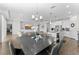 Dining area with modern chandelier that opens to the living room and kitchen at 2926 Wordsmith Rd, Kissimmee, FL 34746