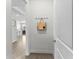 Bright and airy entryway featuring wood-look tile flooring and a coat rack at 2926 Wordsmith Rd, Kissimmee, FL 34746