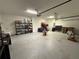 A spacious garage with bright lighting, shelving for storage and a door leading to the interior at 2926 Wordsmith Rd, Kissimmee, FL 34746