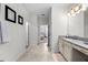 Hallway leading to bathroom featuring tile floor, updated fixtures and neutral wall color at 2926 Wordsmith Rd, Kissimmee, FL 34746