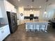 Beautiful kitchen featuring a center island with seating, stainless steel appliances, and white cabinetry at 2926 Wordsmith Rd, Kissimmee, FL 34746