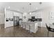 Modern kitchen featuring stainless steel appliances, gray countertops, and an island with bar stools at 2926 Wordsmith Rd, Kissimmee, FL 34746