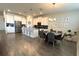 Spacious kitchen with stainless steel appliances, white cabinetry, island, and dining area at 2926 Wordsmith Rd, Kissimmee, FL 34746