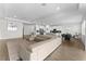 Spacious living area showcasing a modern sectional sofa and open floor plan to kitchen at 2926 Wordsmith Rd, Kissimmee, FL 34746
