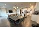 Open-concept living area features a kitchen, dining area, and living room with large television at 2926 Wordsmith Rd, Kissimmee, FL 34746