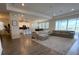Expansive living room with wood floors, large windows, and a comfortable sectional sofa at 2926 Wordsmith Rd, Kissimmee, FL 34746