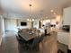 Bright, open-concept living area with modern lighting and an open kitchen, designed for entertaining at 2926 Wordsmith Rd, Kissimmee, FL 34746