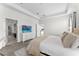 Bright main bedroom featuring neutral colors, tray ceiling, and entry to main bathroom at 2926 Wordsmith Rd, Kissimmee, FL 34746