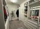 Spacious walk-in closet featuring custom storage solutions, mirrors, and carpeting at 2926 Wordsmith Rd, Kissimmee, FL 34746