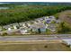 A picturesque aerial shot of homes in a residential area with a scenic backdrop, highlighting the serene surroundings at 3033 Beau Loop, Tavares, FL 32778